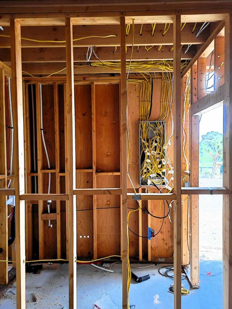 Rough-in wiring through wall studs to a junction box in a new build